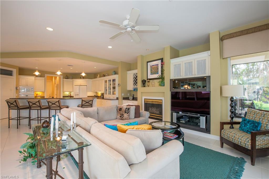 20128 Cheetah Lane Estero, FL 33928 - Photo 21 of 30 a living room with fireplace furniture and a kitchen view
