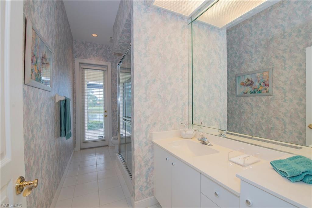 20128 Cheetah Lane Estero, FL 33928 - Photo 22 of 30 a spacious bathroom with a granite countertop sink and a mirror