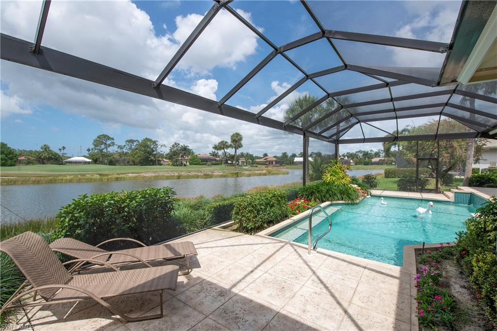 20128 Cheetah Lane Estero, FL 33928 - Photo 26 of 30 a view of a lake with couches and pool