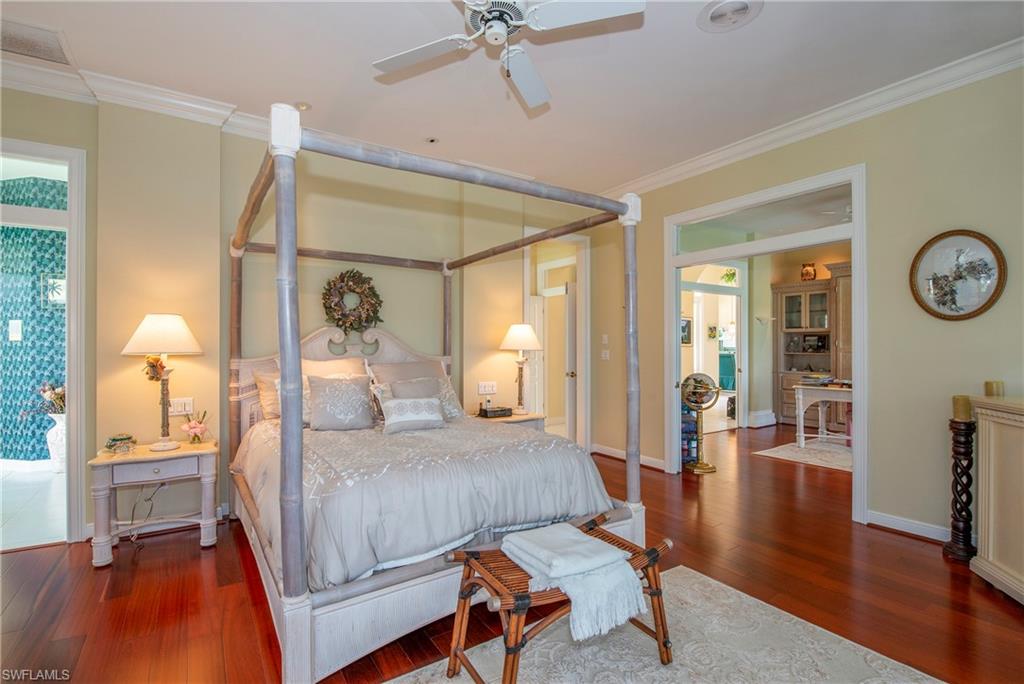 20128 Cheetah Lane Estero, FL 33928 - Photo 8 of 30 a bedroom with a bed window and a table with wooden floor