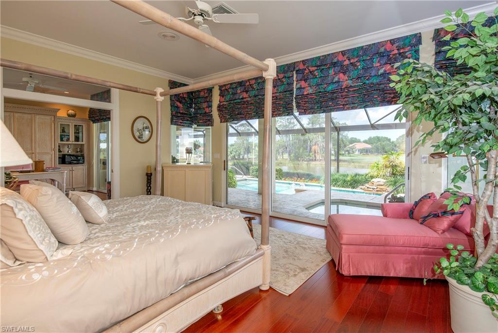 20128 Cheetah Lane Estero, FL 33928 - Photo 9 of 30 a spacious bedroom with a bed and a large window