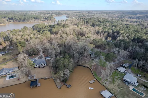 an aerial view of a house with a yard and lake view