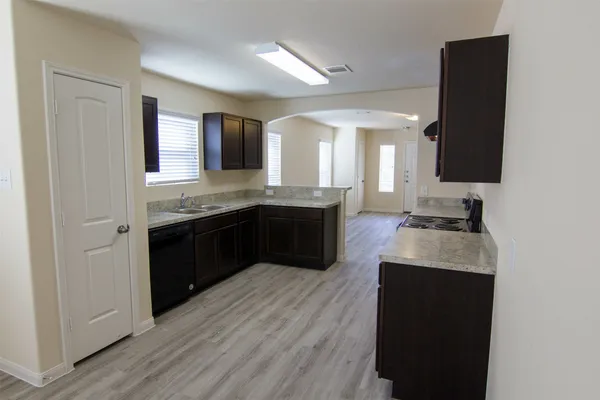 a kitchen with a sink and a stove top oven