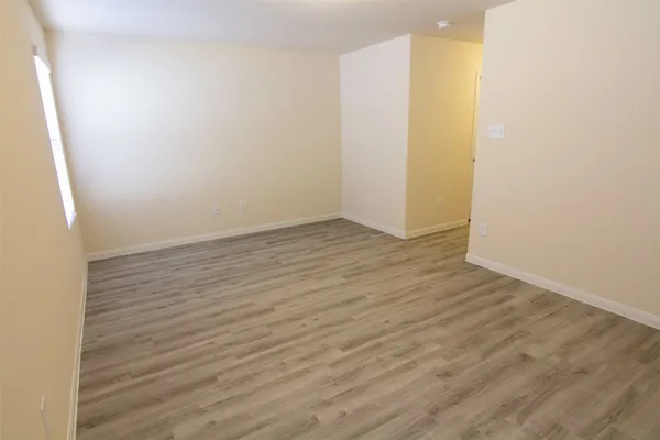 an empty room with wooden floor