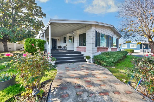 a view of a house with fountain and a pathway