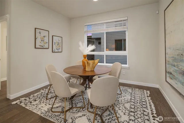 a dining room with furniture and wooden floor