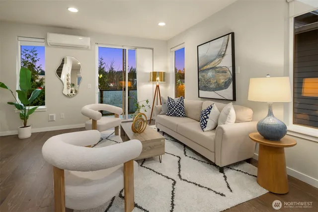 a living room with furniture and potted plants