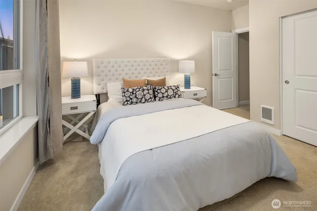 a bathroom with a granite countertop sink a mirror and shower
