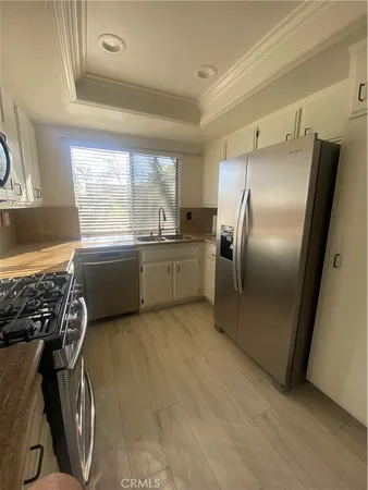 a stove top oven sitting inside of a kitchen