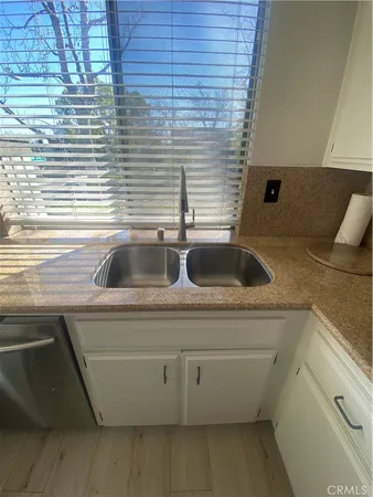 a kitchen with stainless steel appliances a stove sink and microwave