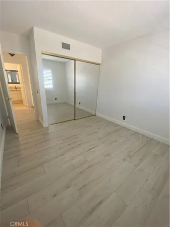 an empty room with an entrance and wooden door