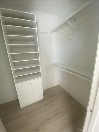 an empty room with windows and ceiling fan