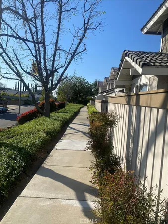 a view of a pathway with a house in back yard