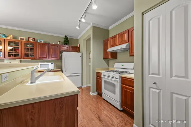 a kitchen with a sink stove and refrigerator