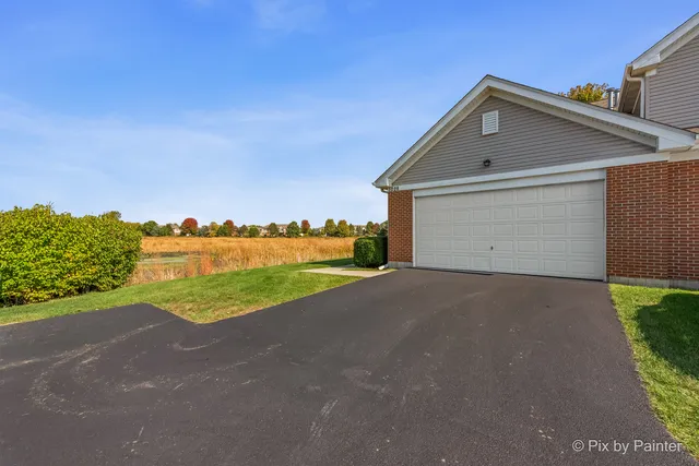 a view of a house with a yard and garage
