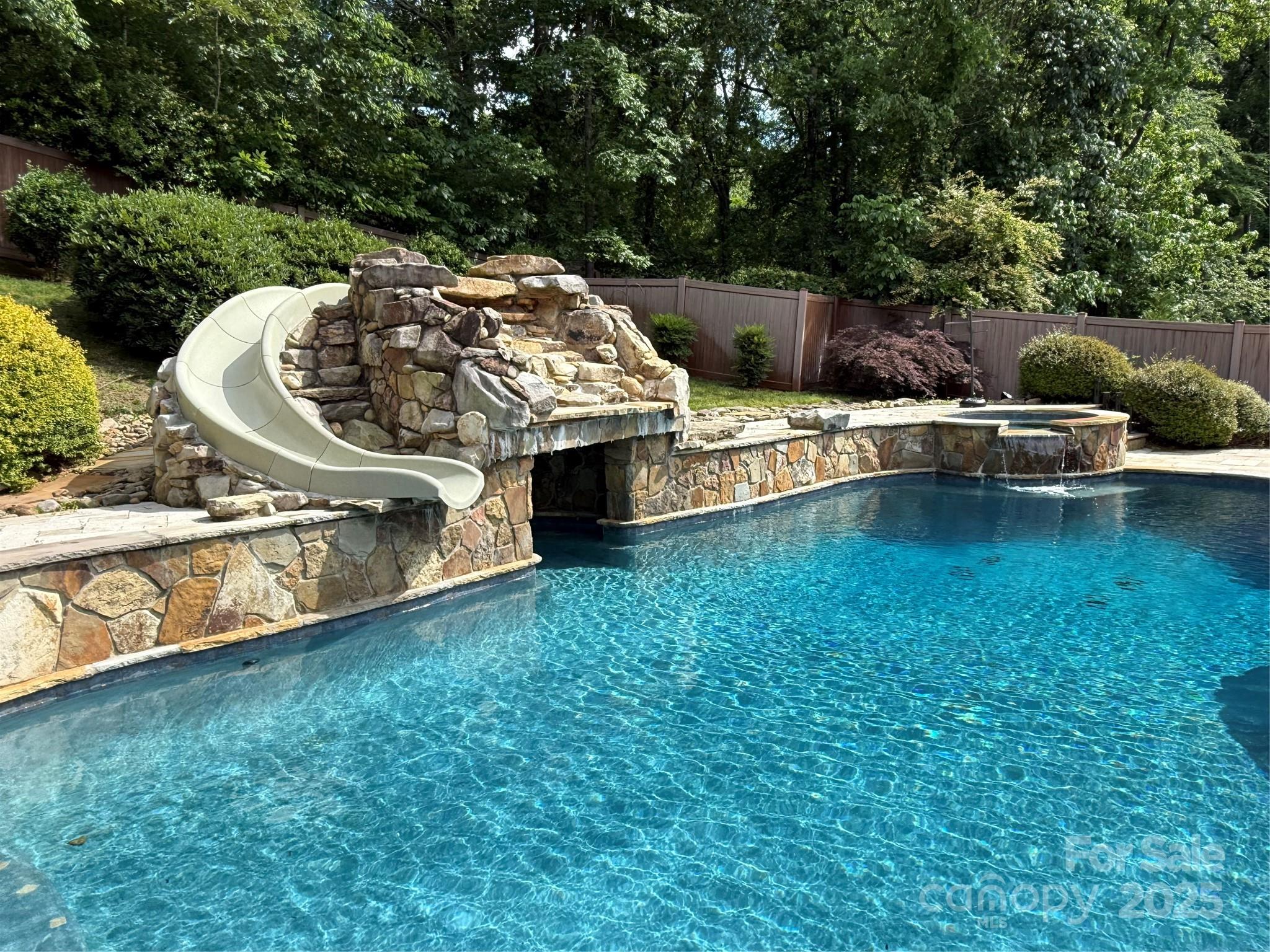 315 Mountainview Drive Charlotte, NC 28270 - Photo 15 of 34 a view of a swimming pool with a yard