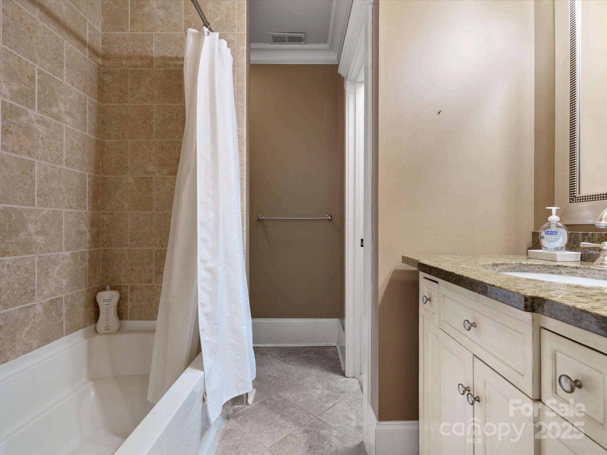 315 Mountainview Drive Charlotte, NC 28270 - Photo 25 of 34 a bathroom with a granite countertop sink and a bathtub