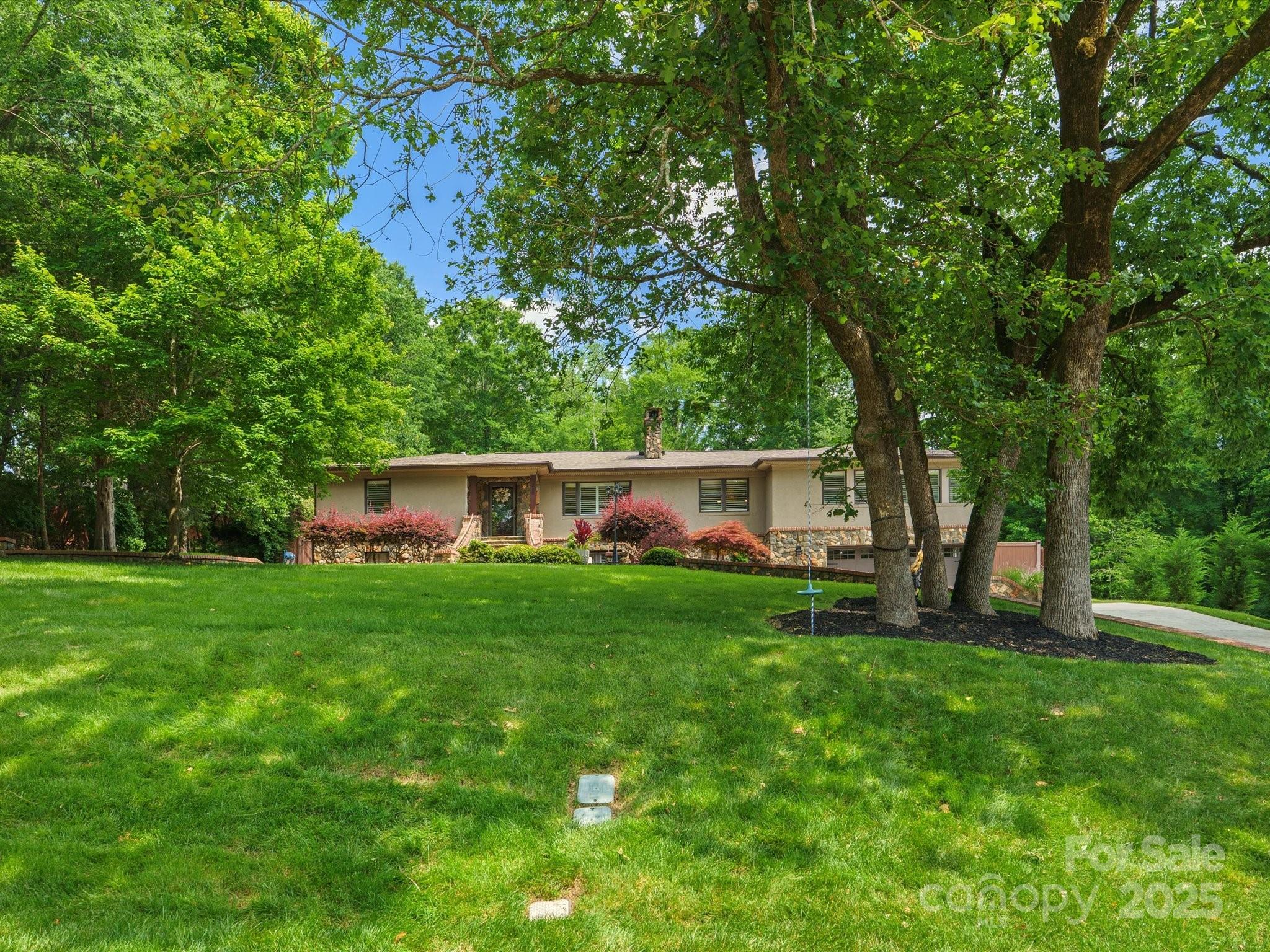 315 Mountainview Drive Charlotte, NC 28270 - Photo 34 of 34 a view of a backyard with table and chairs and large trees