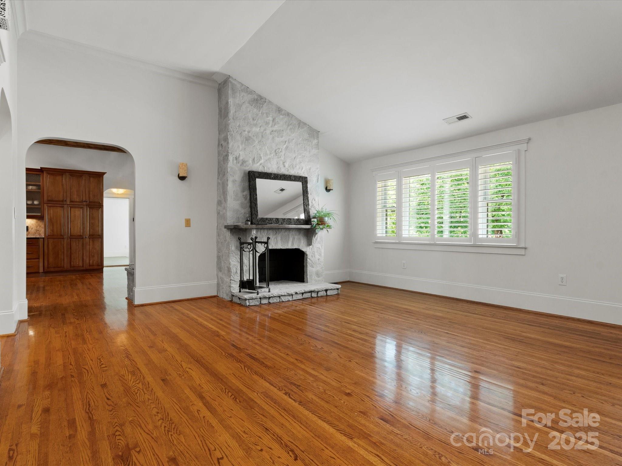 315 Mountainview Drive Charlotte, NC 28270 - Photo 4 of 34 a view of empty room with wooden floor and fireplace