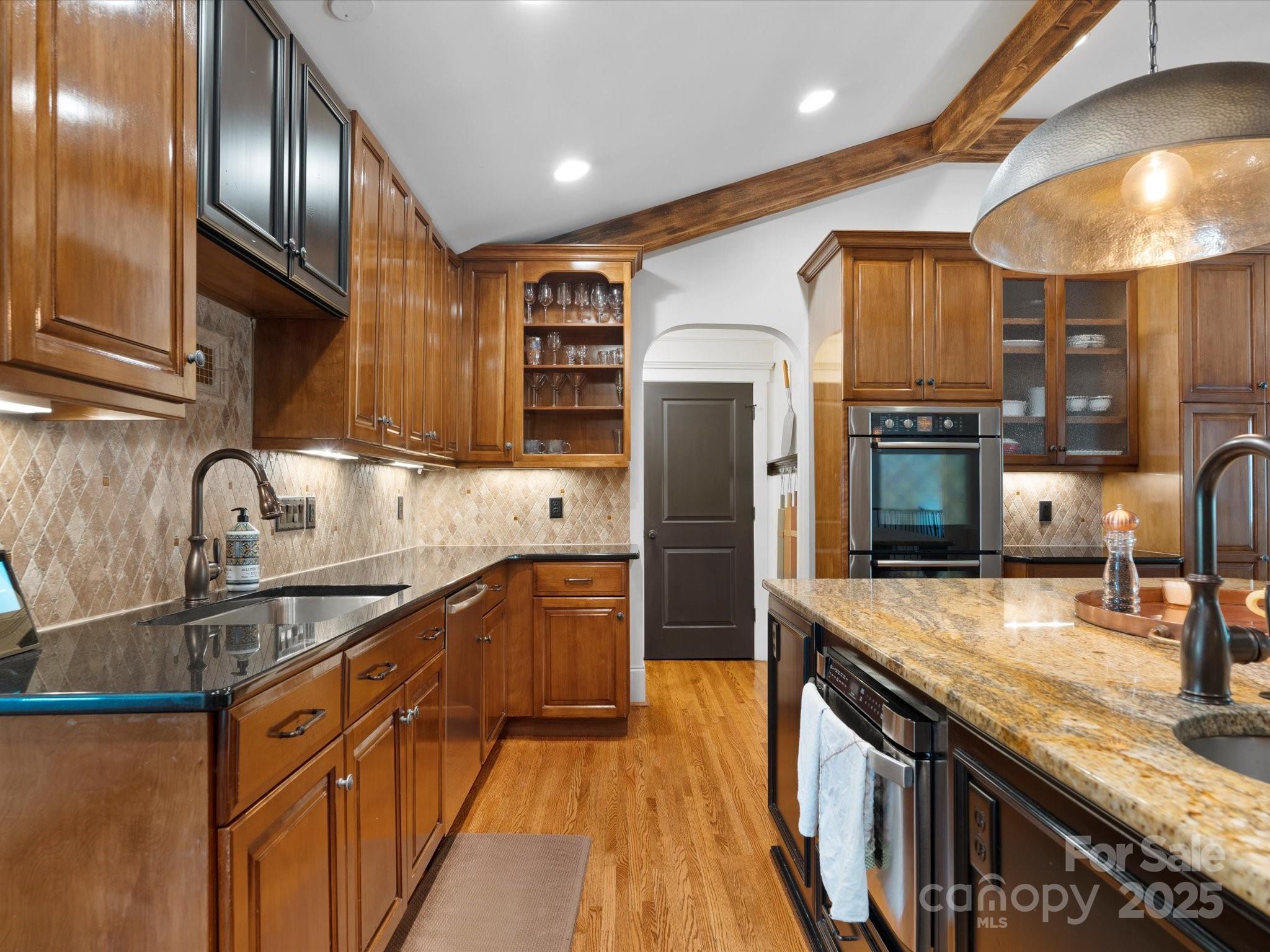 315 Mountainview Drive Charlotte, NC 28270 - Photo 6 of 34 a kitchen with stainless steel appliances granite countertop a sink a stove and a refrigerator