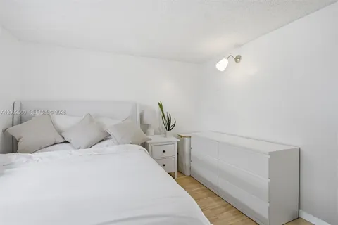 a large white bed in a white room