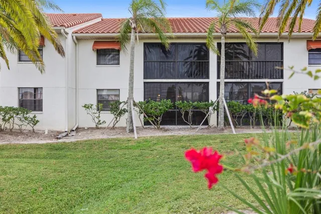 a view of a house with a yard and sitting area