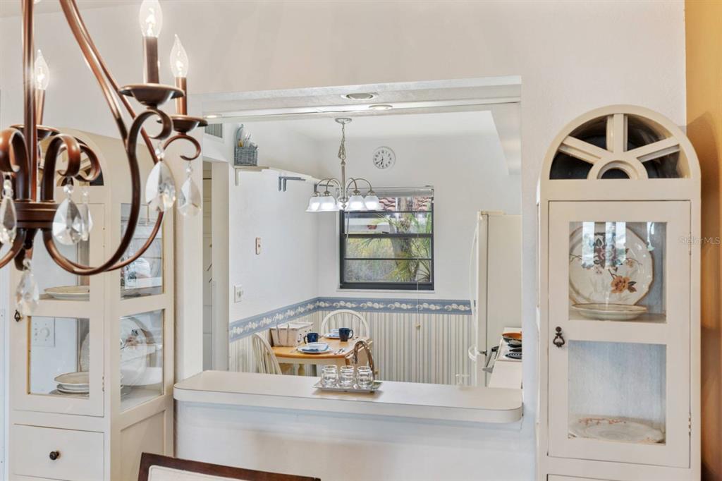 2275 South McCall Road, Unit 102 Englewood, FL 34224 - Photo 12 of 48 a bathroom with a sink a mirror and a window