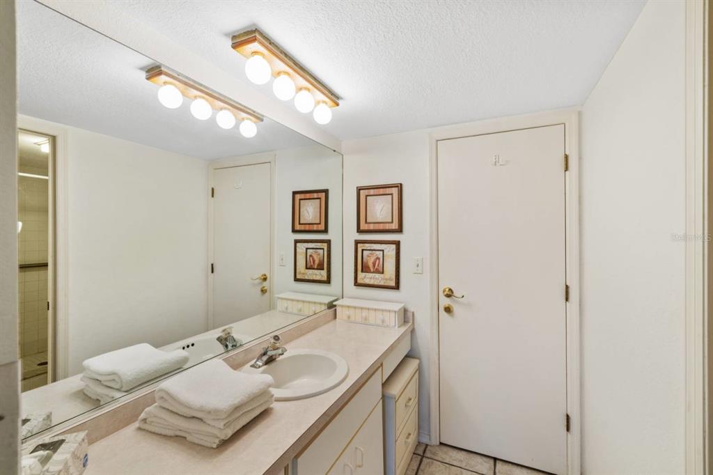 2275 South McCall Road, Unit 102 Englewood, FL 34224 - Photo 20 of 48 a bathroom with a sink and a mirror