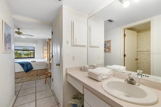 a en suite bathroom with a double vanity sink and a mirror