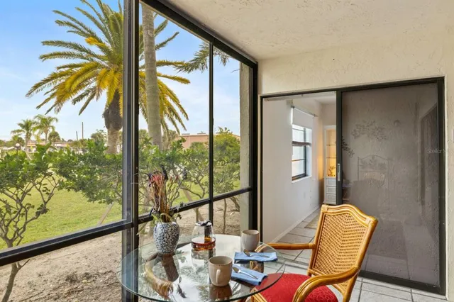 a view of a living room with a floor to ceiling window and wooden floor