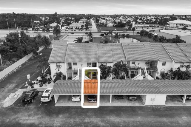 an aerial view of a house with a yard