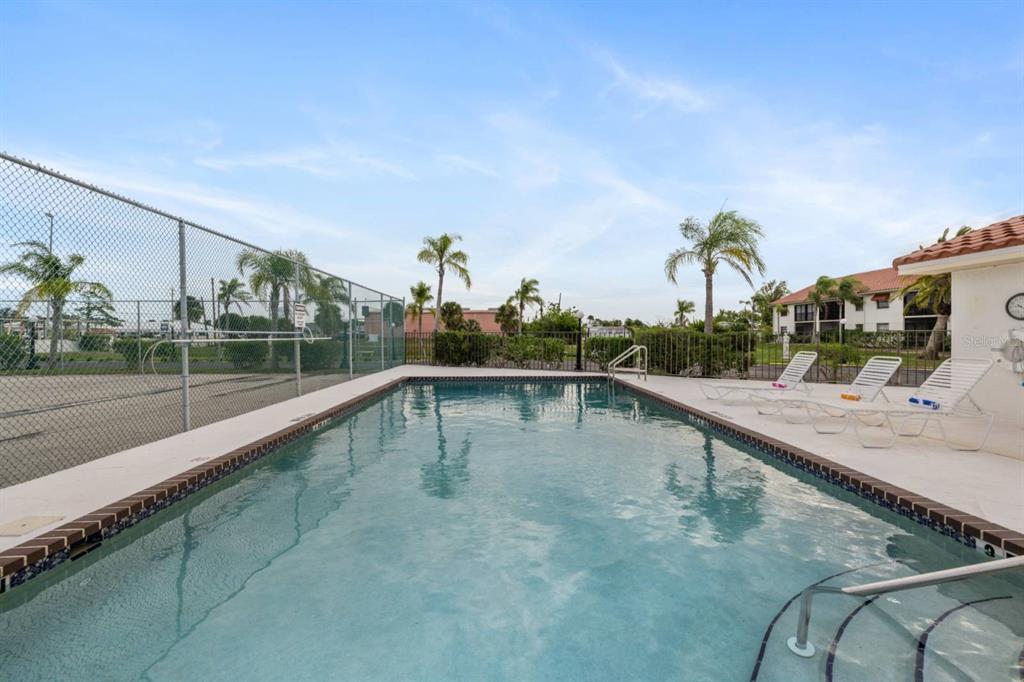 2275 South McCall Road, Unit 102 Englewood, FL 34224 - Photo 39 of 48 a view of a swimming pool with a porch