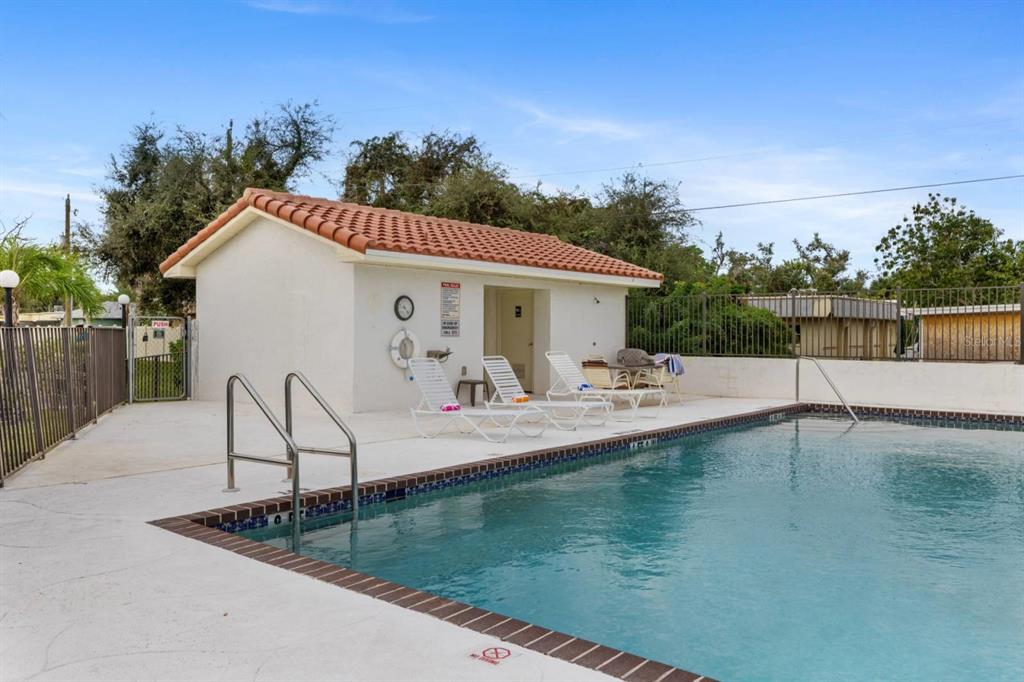 2275 South McCall Road, Unit 102 Englewood, FL 34224 - Photo 42 of 48 a view of a house with pool and sitting area