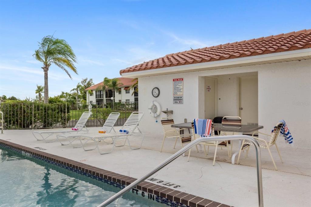 2275 South McCall Road, Unit 102 Englewood, FL 34224 - Photo 43 of 48 a view of a swimming pool with a lounge chair