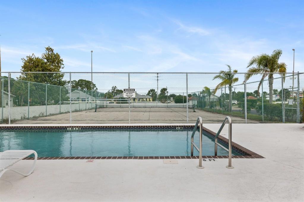 2275 South McCall Road, Unit 102 Englewood, FL 34224 - Photo 44 of 48 a view of a terrace with a bench