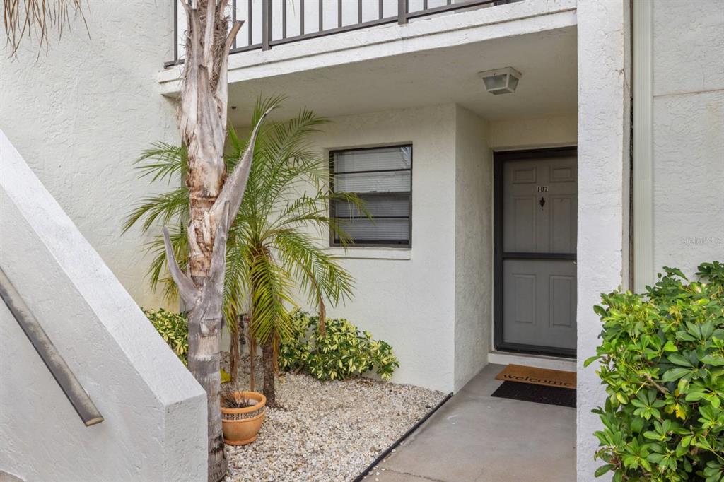 2275 South McCall Road, Unit 102 Englewood, FL 34224 - Photo 48 of 48 a potted plant in front of a door