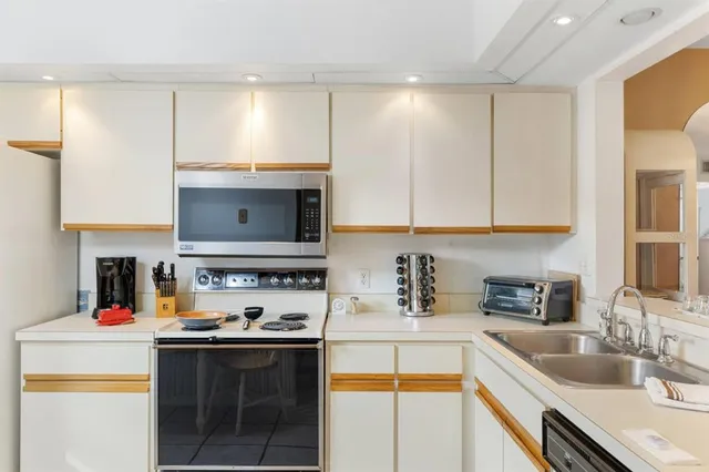 a kitchen with stainless steel appliances a sink stove and cabinets