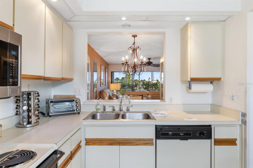 2275 South McCall Road, Unit 102 Englewood, FL 34224 - Photo 8 of 48 a kitchen with a sink and cabinets