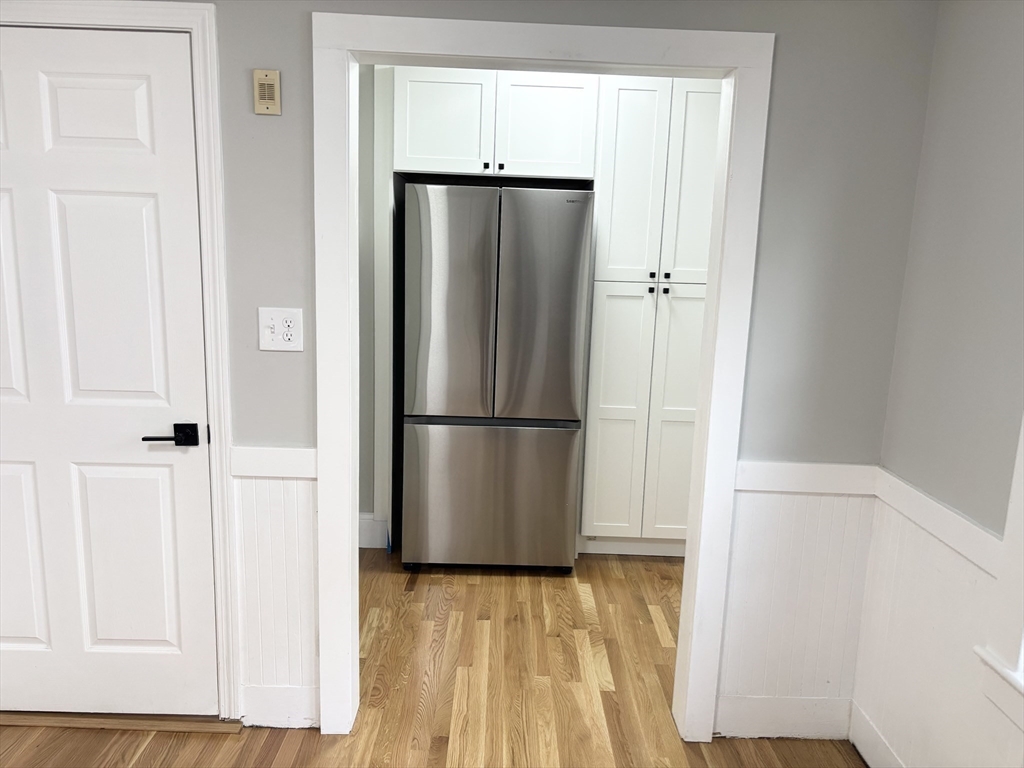 73 Dent Street, Unit 1 Boston, MA 02132 - Photo 12 of 36 a view of closet with wooden floor