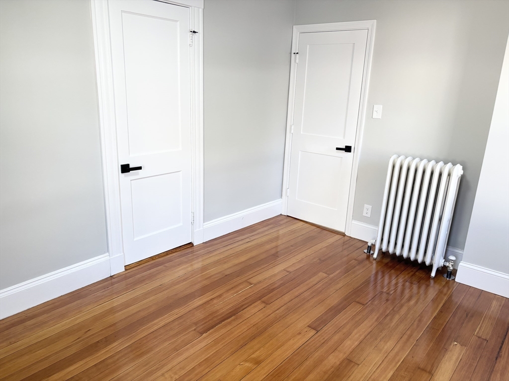 73 Dent Street, Unit 1 Boston, MA 02132 - Photo 17 of 36 a view of a room with wooden floor