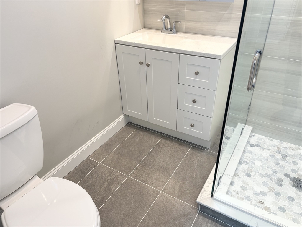 73 Dent Street, Unit 1 Boston, MA 02132 - Photo 20 of 36 a bathroom with a sink and a mirror