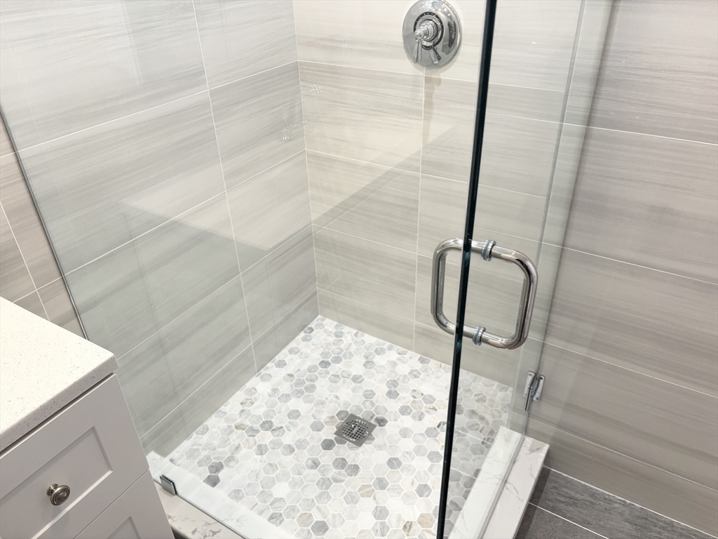 73 Dent Street, Unit 1 Boston, MA 02132 - Photo 22 of 36 a bathroom with a shower