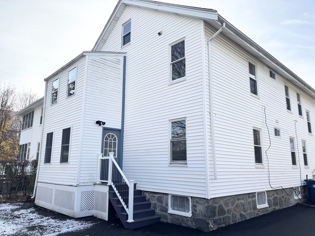 73 Dent Street, Unit 1 Boston, MA 02132 - Photo 4 of 36 a view of a white house with a white door