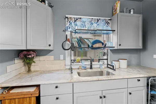 a kitchen with a sink and cabinets