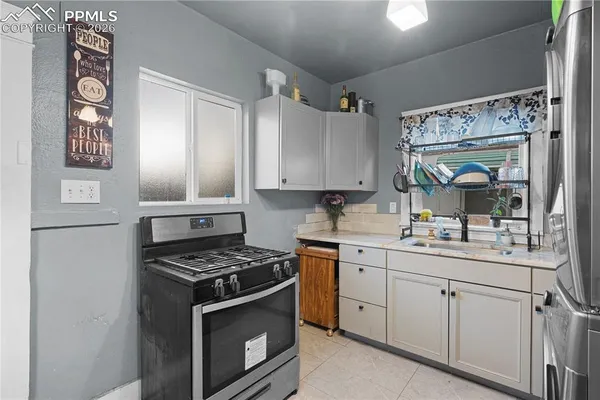 a kitchen with cabinets appliances and a sink