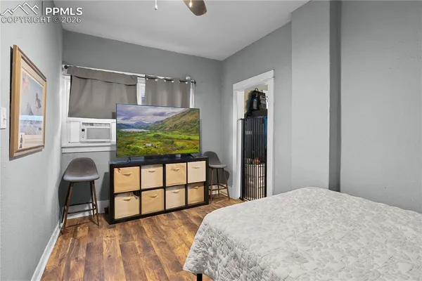 a bedroom with a bed and a flat screen tv