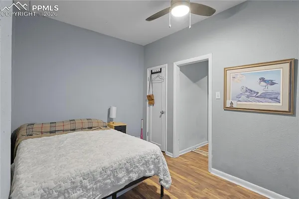 a bedroom with a bed and a painting on the wall