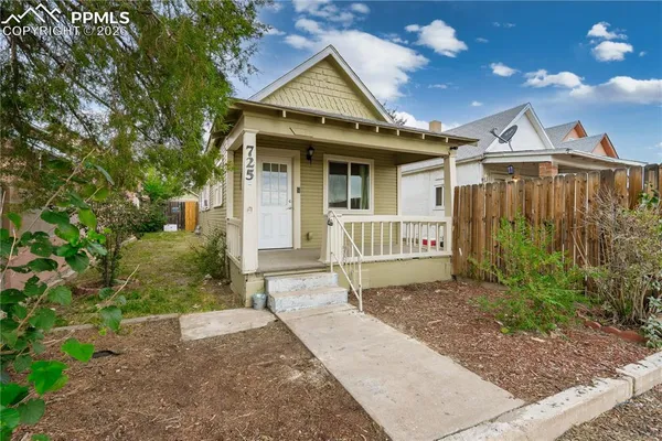 a view of a house with a small yard and plants