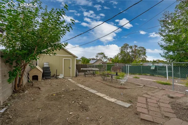 a view of back yard with wooden fence