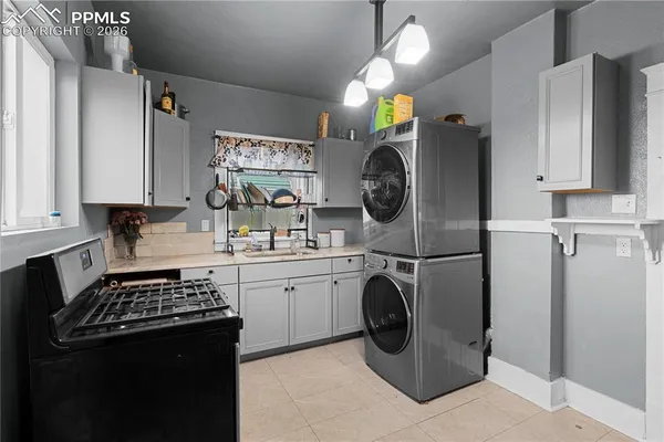 a kitchen with a stove a refrigerator and a sink